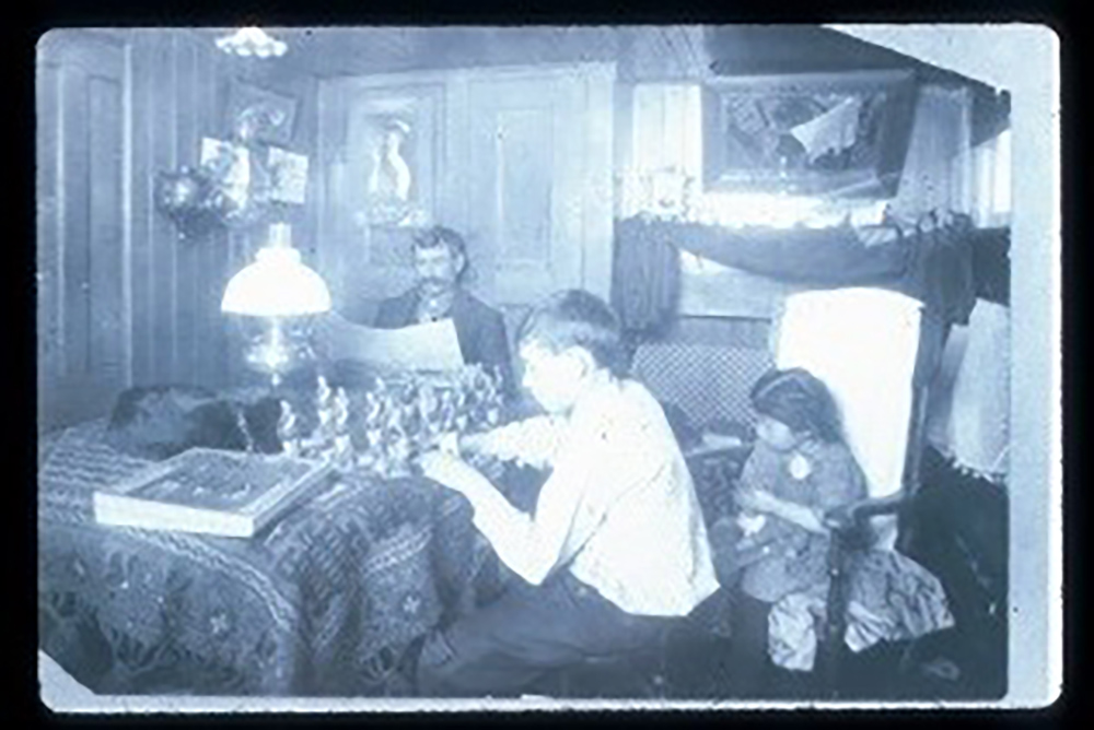 Photograph of the interior of a canal boat cabin, c. 1920 page 1