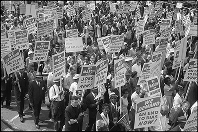 Demonstrators marching in the street holding signs during the March on Washington, 1963 thumbnail page 1