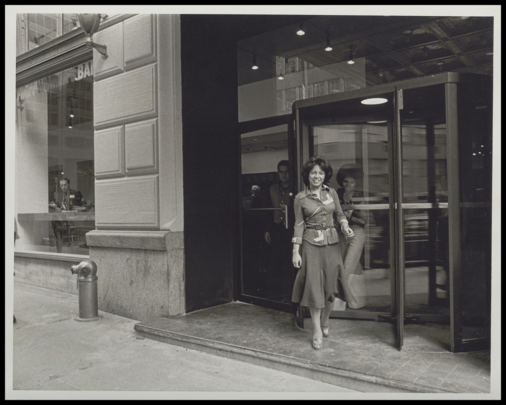 Woman Emerges from Revolving Door of First Women's Bank page 1