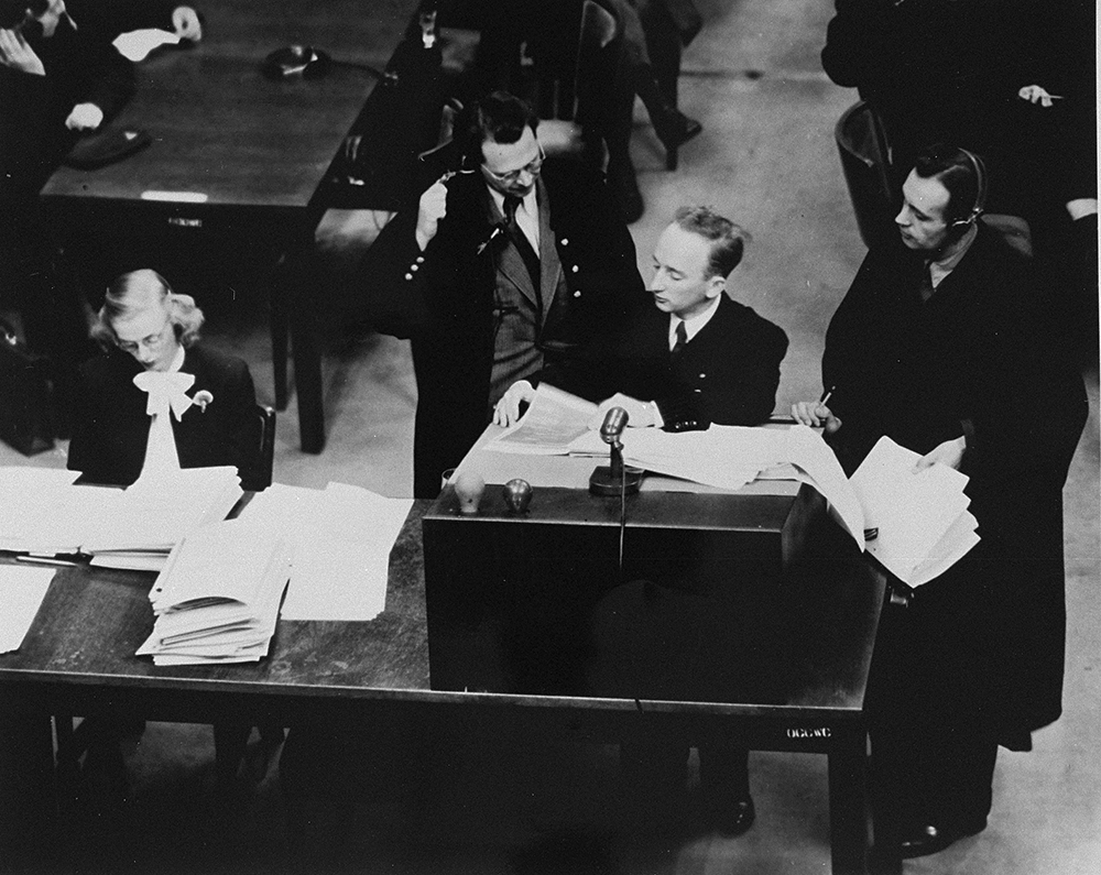 Chief prosecutor Benjamin Ferencz presents documents as evidence at the Einsatzgruppen Trial. page 1