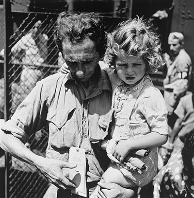 A father holding his daughter at Fort Ontario Refugee Shelter thumbnail page 1