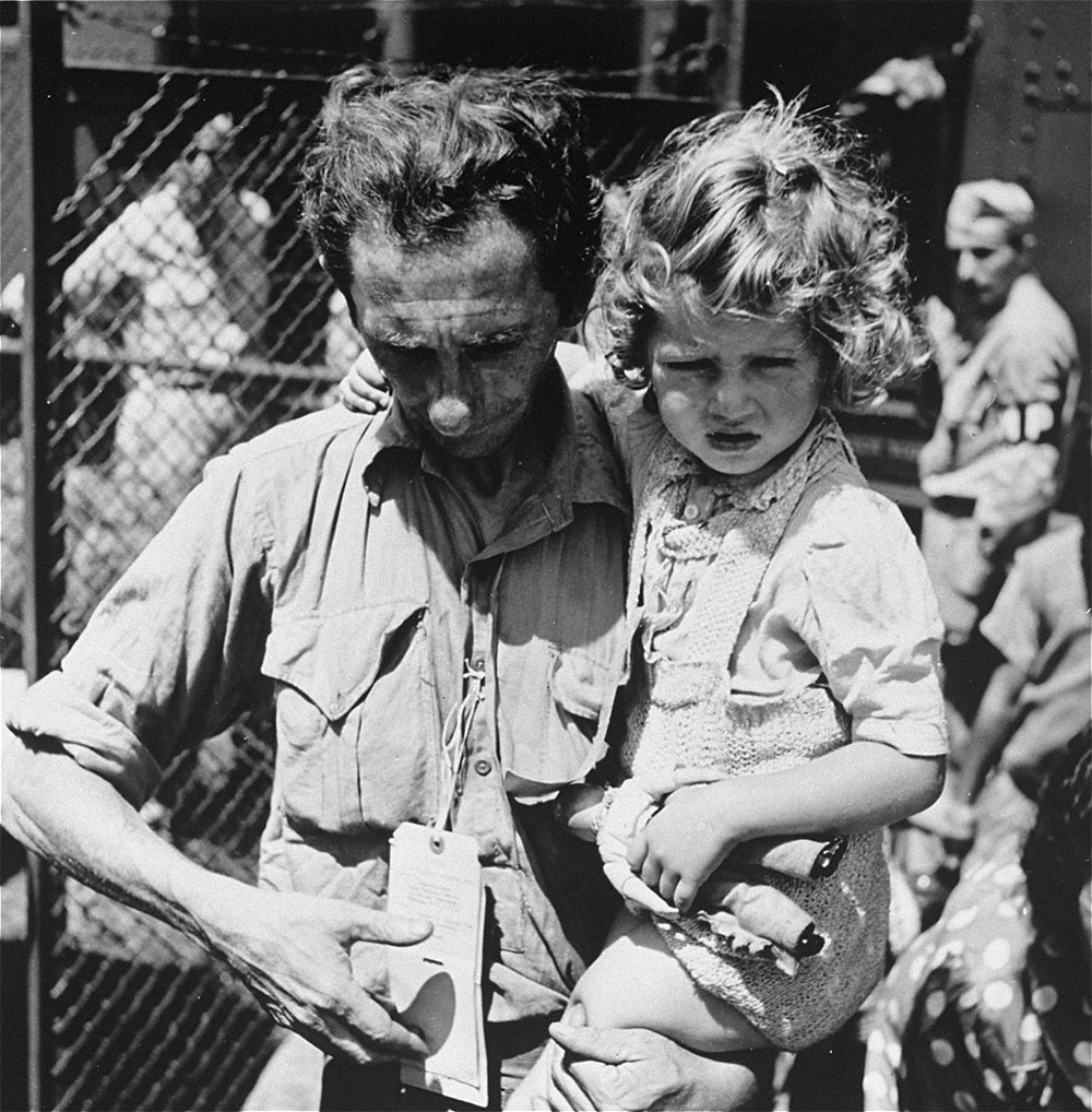 A father holding his daughter at Fort Ontario Refugee Shelter page 1